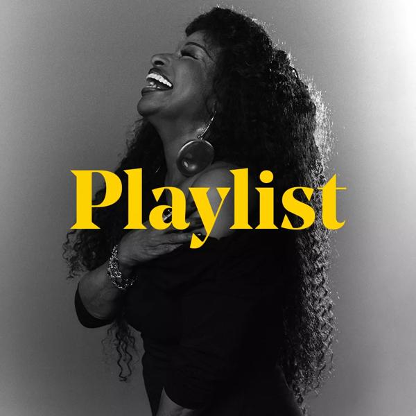 Singer Chaka Khan, a black woman with long curly hair stands side on, she is looking upwards with her mouth open; she wears an over the shoulder dress and her right hand is holding her bare left shoulder. Over the top of this image is the word 'Playlist' in yellow type