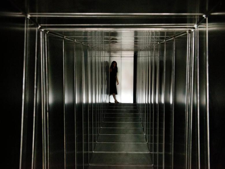 Girl at end of Metal Corridor installation by Carsten Höller in Hayward Gallery  