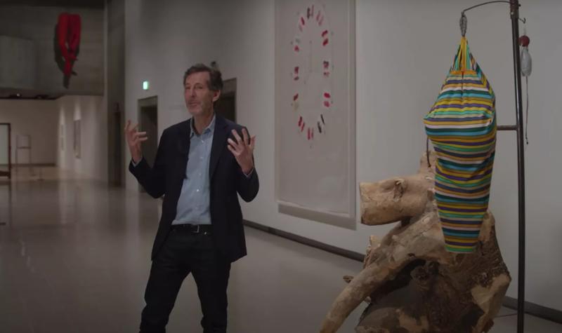 Hayward Gallery Director Ralph Rugoff stands next to an artwork within the exhibition, Louise Bourgeois: The Woven Child