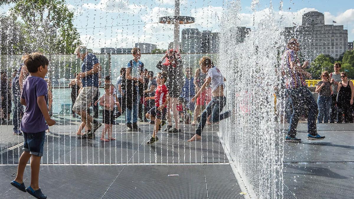 Children play in the Appearing Rooms fountain on the Southbank Centre's Riverside Terrace