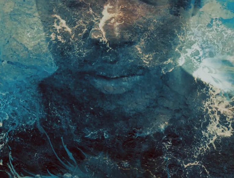 Image of a Black woman's face and shoulders is layered over by a swirling blue ocean. 