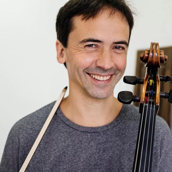 Cellist Jean-Guihen Queyras smiling to the camera