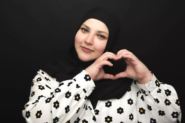 Photo of Fatiha El Ghorri making a heart shape with her hands. 