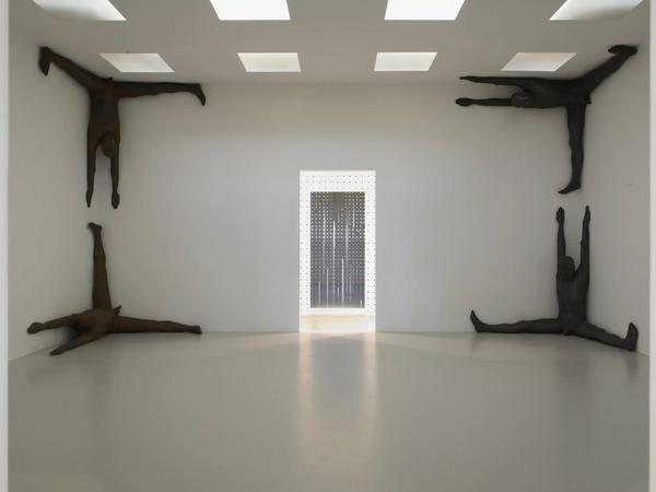 Four Figures of a Man Facing Each other in four Corners of a Room by artist, Antony Gormley at Hayward Gallery