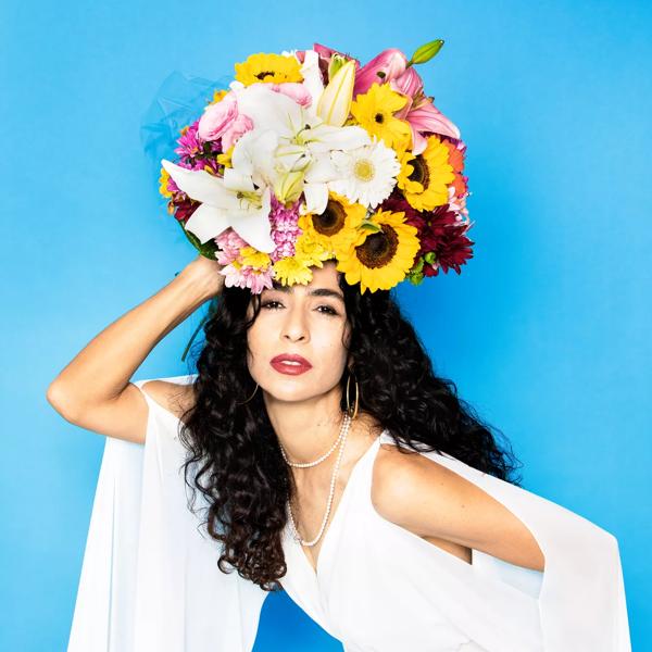 Muician Marisa Monte with flowers on her head 