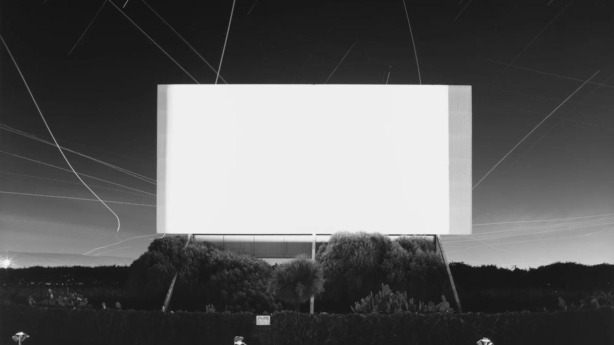 Black and white photograph of a drive in cinema screen