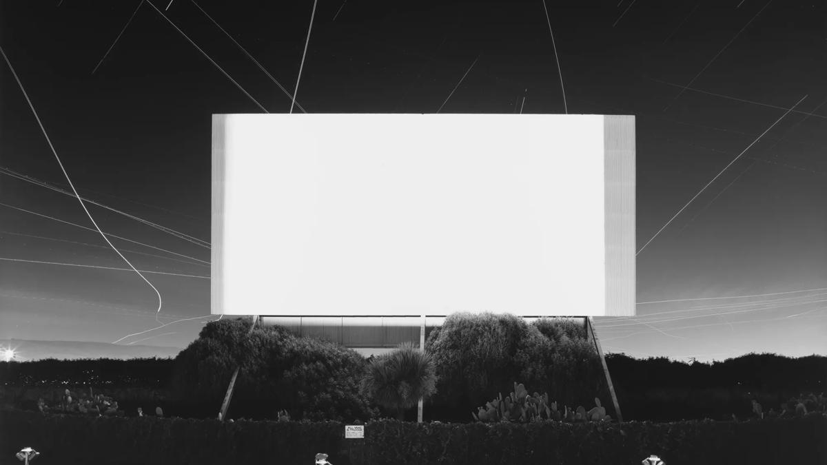 Black and white photograph of a drive in cinema screen