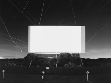 Black and white photograph of a drive in cinema screen