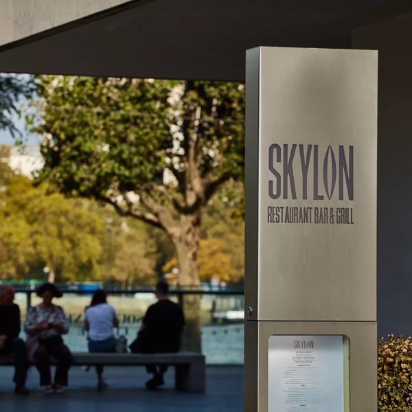 Skylon exterior signage with people sitting in the background