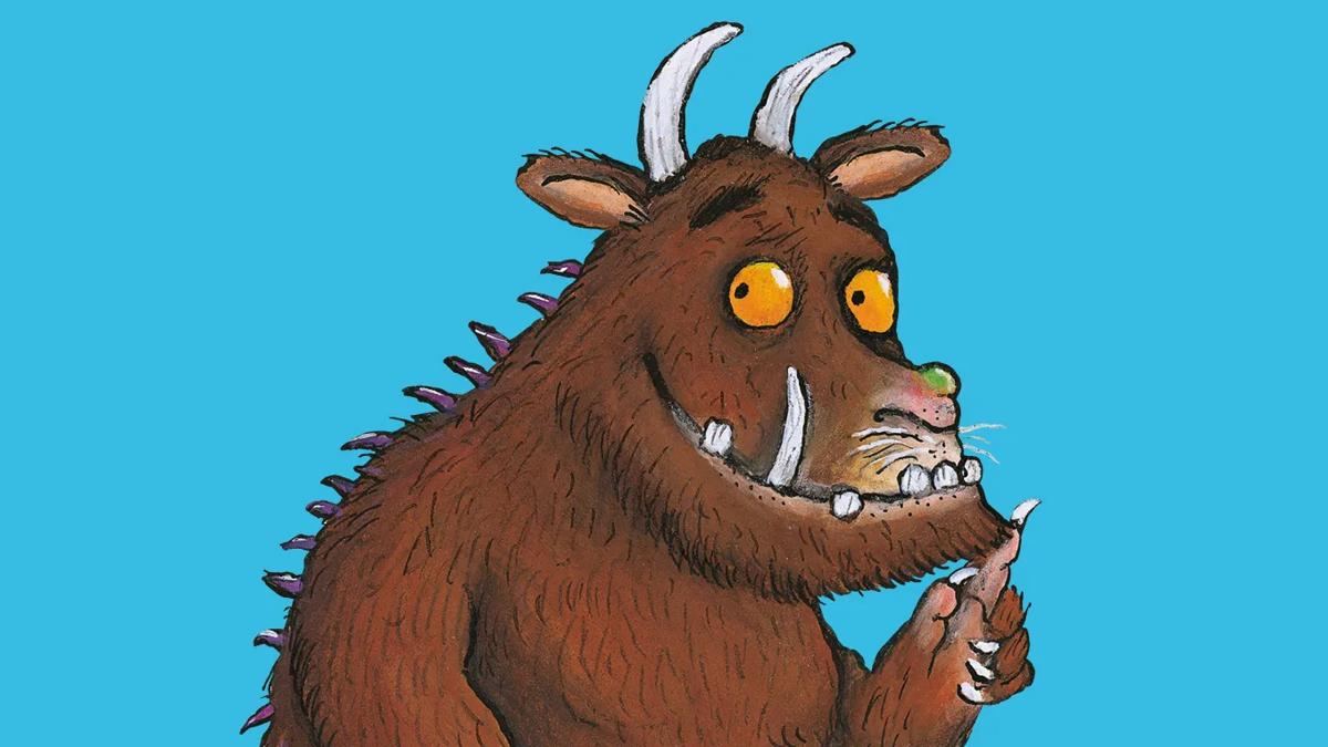 The Gruffalo character against a blue background, looking to the left and smiling.