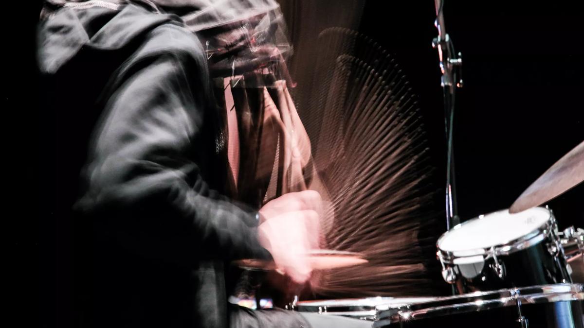 A person plays the drums 