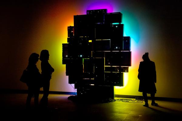 Visitors in Dark Looking at colour Light Installation by artist, David Batchelor at Hayward Gallery