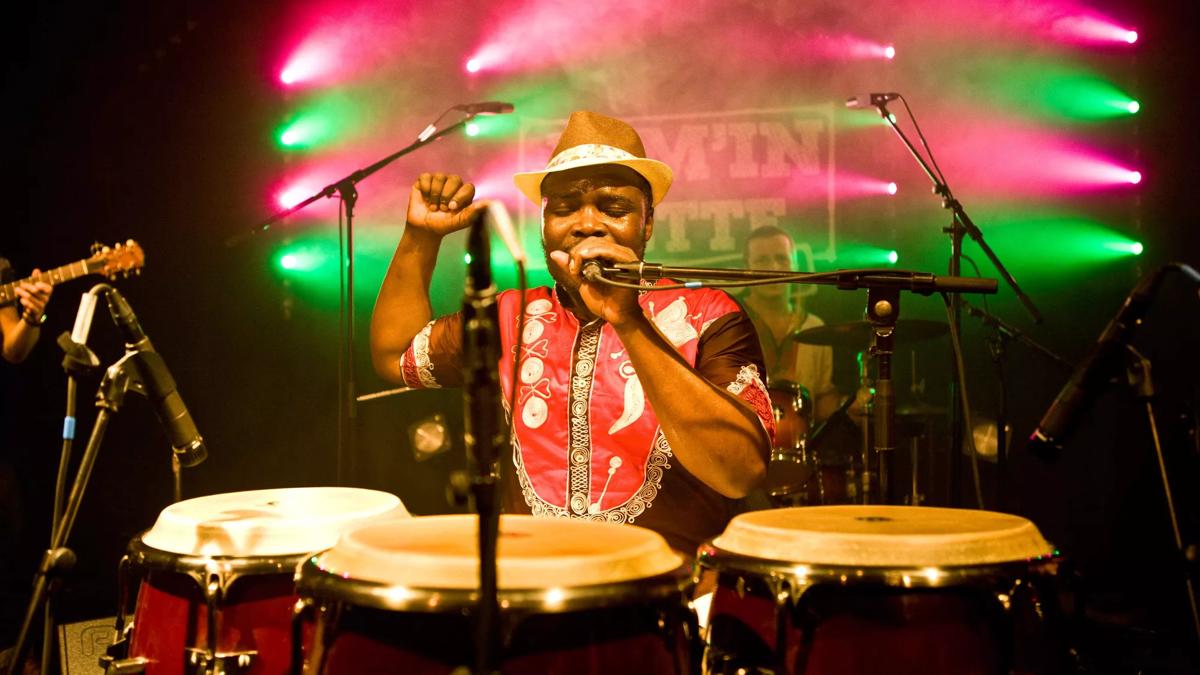 Afla Sackey, percussionist, pictured singing behind his drums 