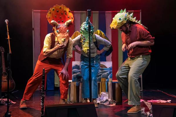 Performers in costume on stage for "Dinosaurs and All That Rubbish". 