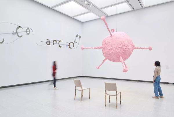 A pink molecular looking structure hanging from the ceiling