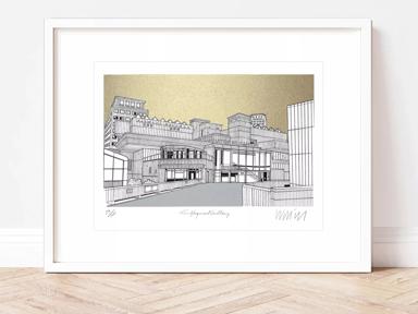 Photo of a framed print leaning against a wall. The print is an architecturalish drawing of the Hayward Gallery
