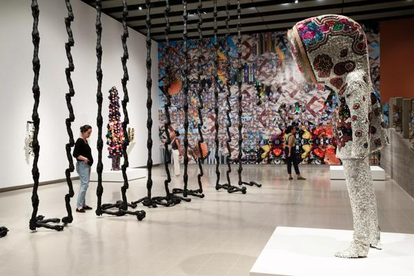 Audience looking at the installation view of Nick Cave works, In the Black Fantastic at Hayward Gallery