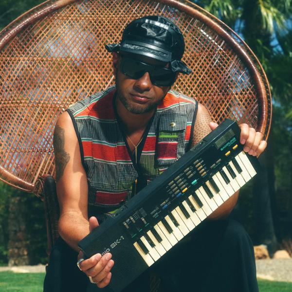A man with sunglasses holding a keyboard