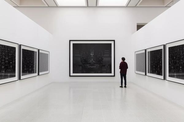 A person looks at Hiroshi Sugimoto, Sea of Buddha installed in the Hayward Gallery.