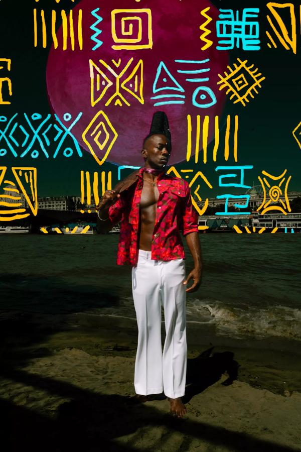 A collage image featuring a Black man in white trousers and an open red shirt standing on the waters edge of the Thames. A bright pattern is marked out over the background in yellow and turquoise