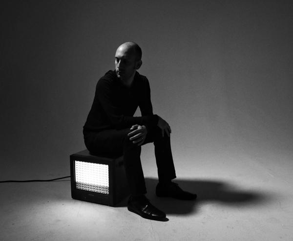 Tristan Perich sat on a light box.