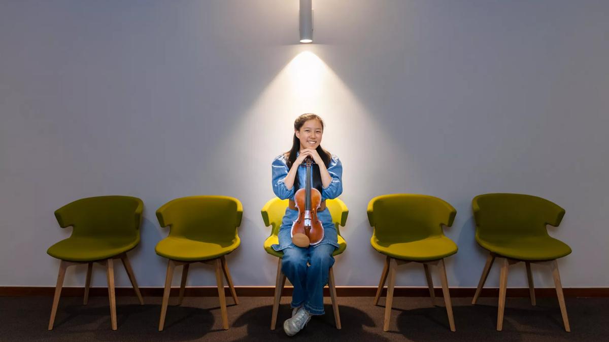 A female violinist under a spotlight 