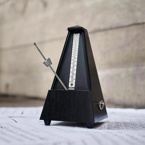 A metronome on top of sheet music