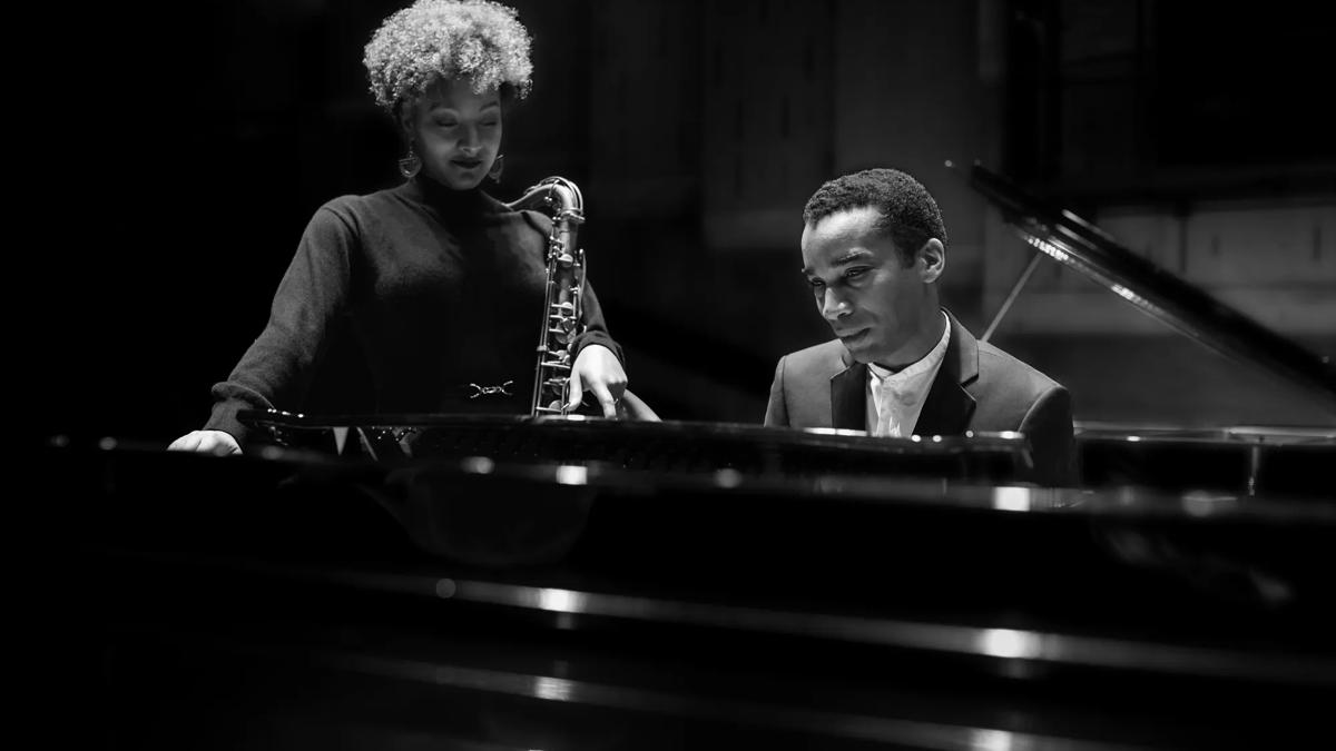 Musician Nubya Garcia with Peter Edwards of Nu Civilisation Orchestra by a piano.