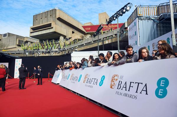A photo of fans on the red carpet.