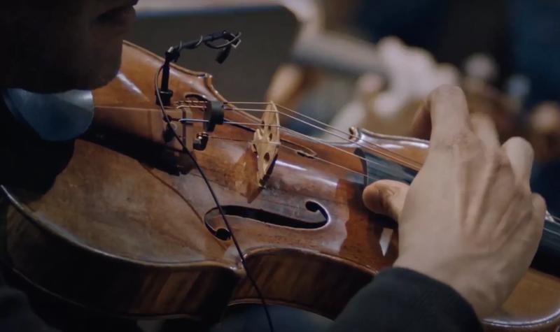 screenshot from A House of Call promotional trailer, showing a close up of a violin being played pizzicato