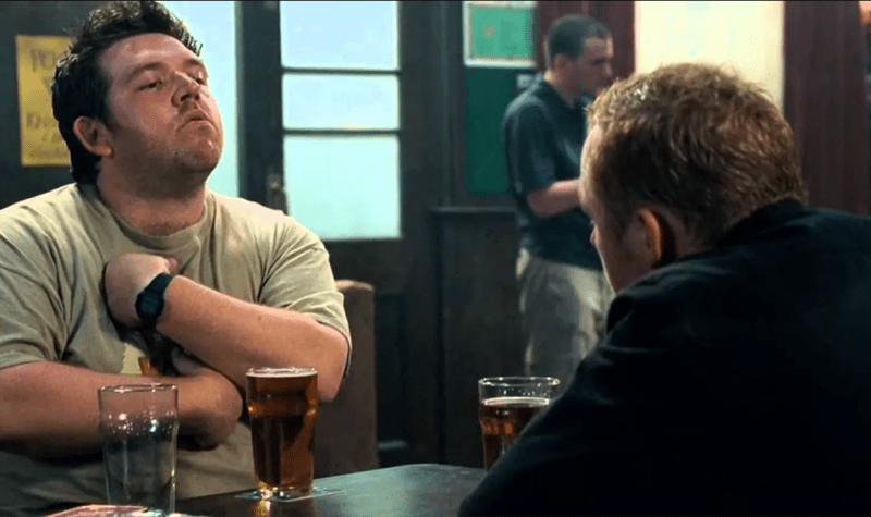 Actors Nick Frost and Simon Pegg sit at a pub table in character during filming of Shaun of the Dead