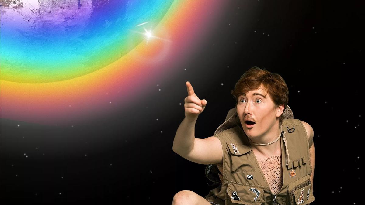 A man crouched down pointing to Earth surrounded by a rainbow