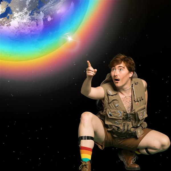 A man crouched down pointing to Earth surrounded by a rainbow