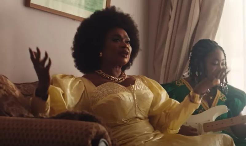 Oumou Sangaré sings from a sofa which she shares with an electric guitarist