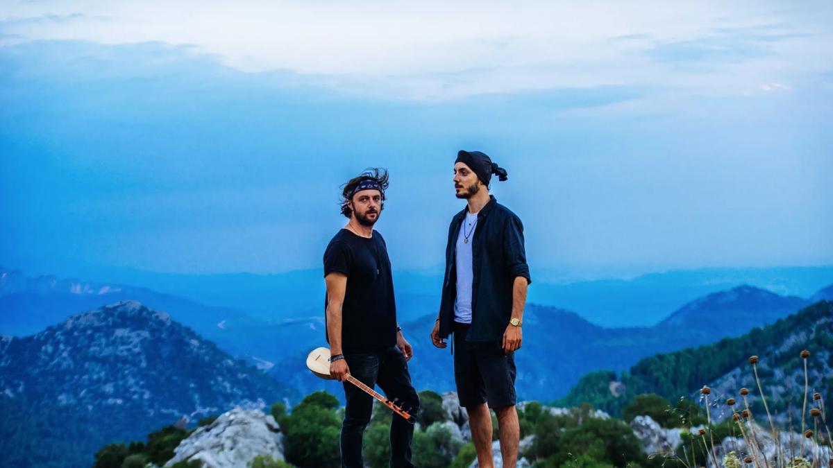 Air Anatolia: two men standing on a mountain wearing black clothing