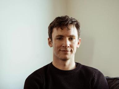 The author Bryan Moriarty, a young white man with dark hair, wearing a dark jumper