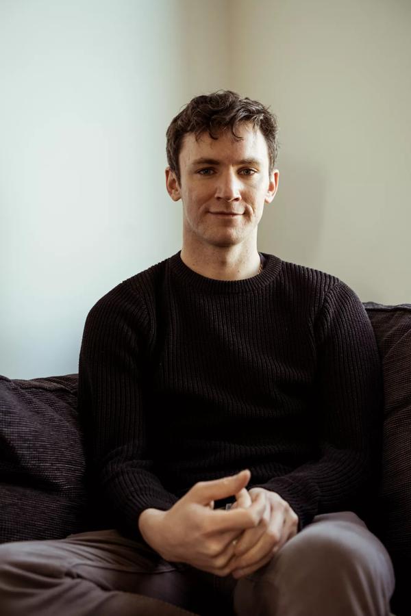 The author Bryan Moriarty, a young white man with dark hair, wearing a dark jumper