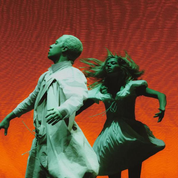 Colourful imagery of two dancers in white costumes from Cowpuncher My Ass