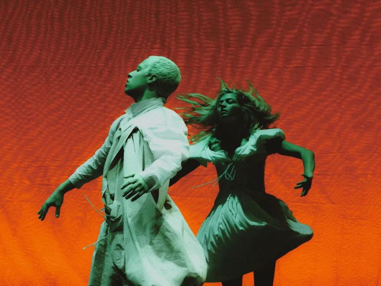 Colourful imagery of two dancers in white costumes from Cowpuncher My Ass