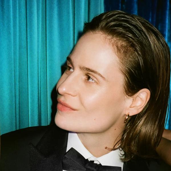 Christine and the Queens in a suit looking to the left