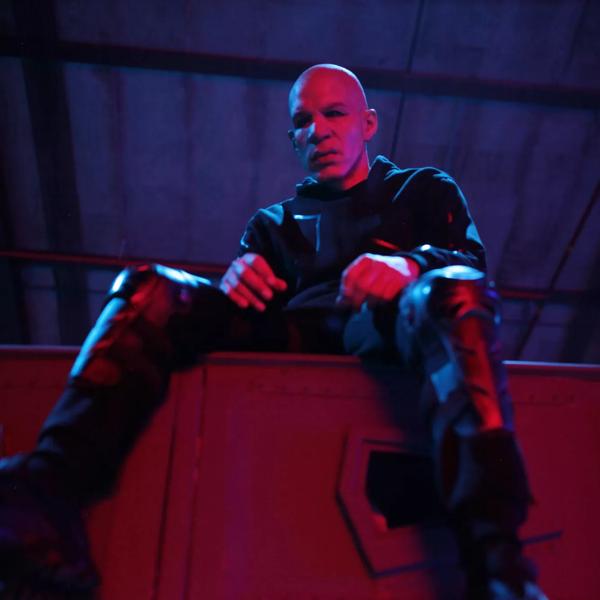 Musician CASisDEAD sitting on a red metal locker