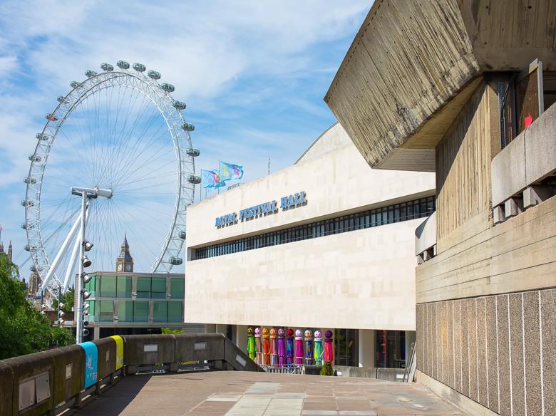 View of the Royal Festival Hall building with the London Eye in the background at the Southbank Centre