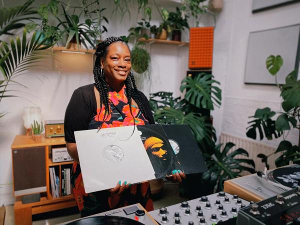 A woman with braids holding vinyls 
