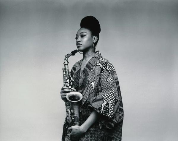 Musician Camilla George with a saxophone in hand