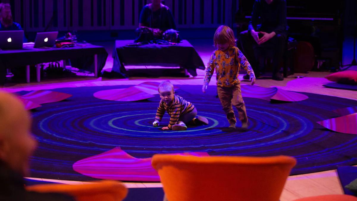 Slumber Stories, two kids playing on a round carpet
