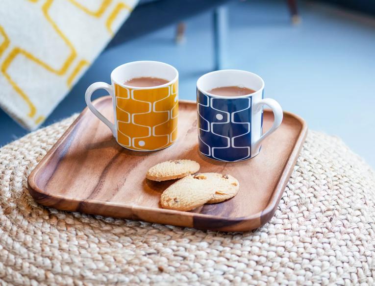 Two Southbank Centre tea mugs and biscuits on a tray