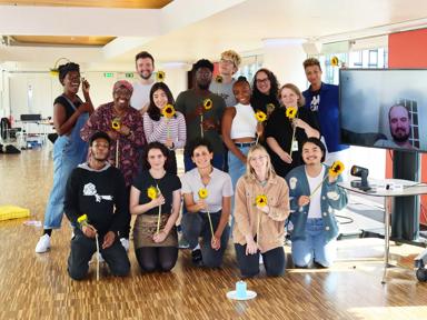 A photo of people holding sunflowers