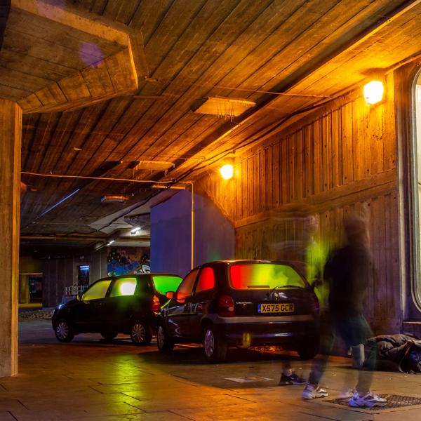 Anne Roininen's light sculpture Car Show (2017-21) which consists of 'abandoned' vehicles illuminated by light from within, in situ outside Queen Elizabeth Hall, Southbank Centre as part of Winter Light