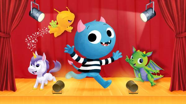 Colourful cartoon monster characters performing on a stage with red curtains.