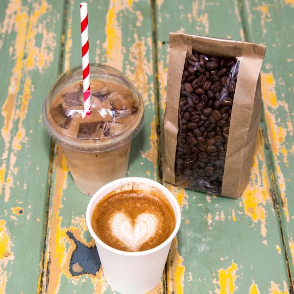 Photo showing a caffe latte, an iced coffee and a bag of coffee beans,  sold by For The Good of the People at Southbank Centre Food Market